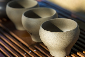 Ceramic bowls made of clay on a wooden background.
