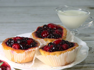 Tartlet cake, with raspberry and strawberry jam. Confectionery on a white plate for a children's...