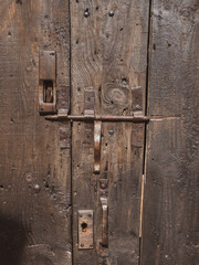 detail of an old wooden door with metal fittings