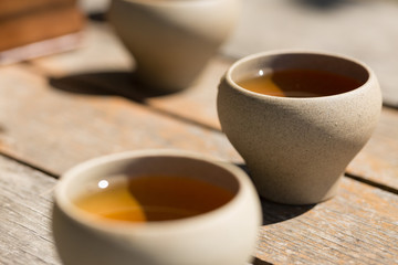 Ceramic bowls made of clay on a wooden background.