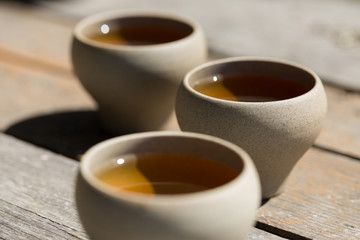 Ceramic bowls made of clay on a wooden background.
