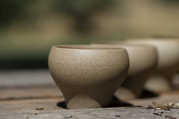 Ceramic bowls made of clay on a wooden background.