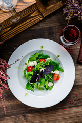 summer salad on a plate with fresh vegetables, seasonal offer for the menu