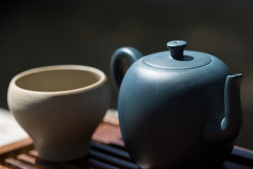 Chinese tea ceremony. Ceramic teapot made of clay and bowls on a wooden background.