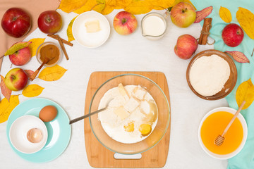 ingredients and recipe for homemade Apple cupcakes and muffins, top view light background, yellow leaves. the concept of fall baking and fall harvest. mixing flour, eggs and butter, knead the dough