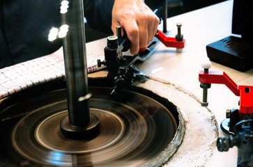 Amsterdam, Netherlands - July 2019: A skilled worker are shaping diamond they at the factory in Amsterdam, Netherlands.