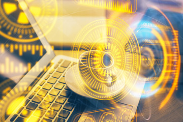 Computer on desktop in office with technology theme hologram. Double exposure. Tech concept.