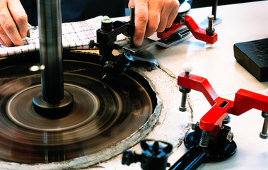 Amsterdam, Netherlands - July 2019: A skilled worker are shaping diamond they at the factory in Amsterdam, Netherlands.