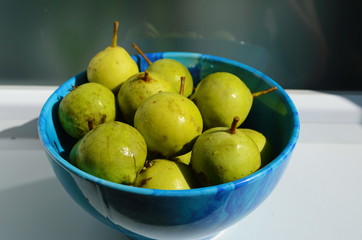 Fresh little pear in the blue plate.