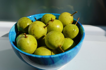Fresh little pear in the blue plate.