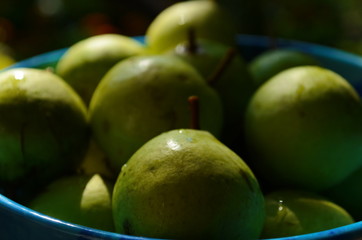 Fresh little pear in the blue plate.