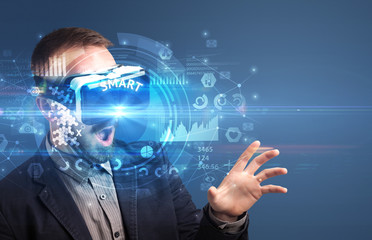 Businessman looking through Virtual Reality glasses with SMART inscription, innovative technology concept