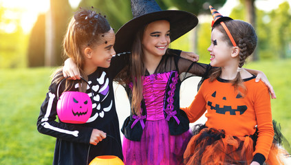 Happy Halloween! funny children in carnival costumes outdoors.