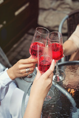 People hold in hands glasses with pink champagne. party.