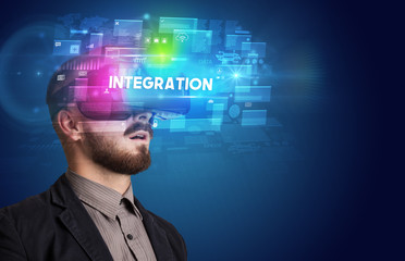 Businessman looking through Virtual Reality glasses with INTEGRATION inscription, innovative security concept