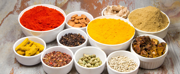 Aromatic spices on wooden spoons. Food ingradients.

