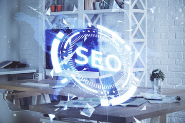 Multi exposure of table with computer and seo drawing hologram. Search optimization concept.