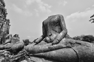 Black and white image of headless buddha images in Thai temple