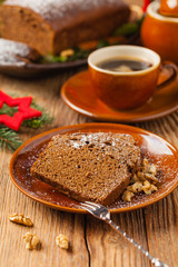Homemade gingerbread cake. Christmas decoration. Front view. Natural wooden background.