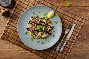 Fried veal, with rice, Chinese cabbage and mushrooms. Sprinkled with sesame and soy sauce.