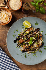 Fried veal, with rice, Chinese cabbage and mushrooms. Sprinkled with sesame and soy sauce.