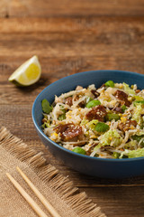 Fried veal, with rice, Chinese cabbage and mushrooms. Sprinkled with sesame and soy sauce.