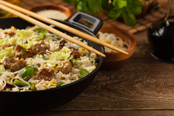 Fried veal, with rice, Chinese cabbage and mushrooms. Sprinkled with sesame and soy sauce.