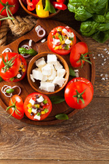 Fototapeta na wymiar Greek stuffed tomato with feta cheese, olives, and fresh pepper.
