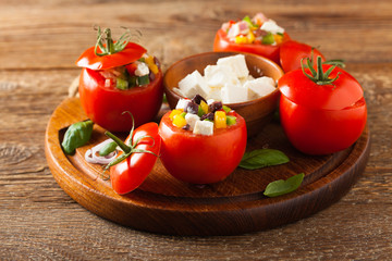 Greek stuffed tomato with feta cheese, olives, and fresh pepper.