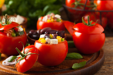 Greek stuffed tomato with feta cheese, olives, and fresh pepper.