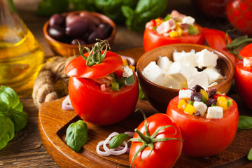 Greek stuffed tomato with feta cheese, olives, and fresh pepper.