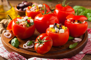 Greek stuffed tomato with feta cheese, olives, and fresh pepper.