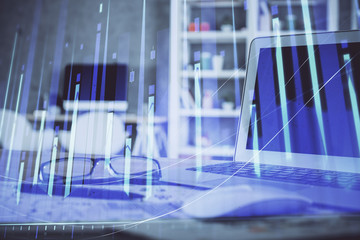 Stock market graph and table with computer background. Multi exposure. Concept of financial...