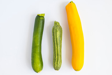 Metaphor, symbol of multiracial, interracial family composed by three zucchini in different variety and colors.