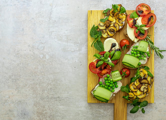 Great vegetarian appetizers with different toppings, top view. Flat lay of rye bread toasts.