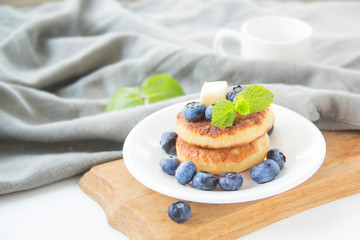 A healthy breakfast of pancakes, berries, butter, and honey