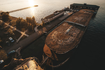 Abandoned boat on the water. Ship at sunset. The view from the top.
