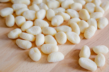 Gnocchi, typical italian pasta, on wooden table, natural light