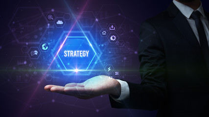 Man hand holding STRATEGY inscription, social media concept