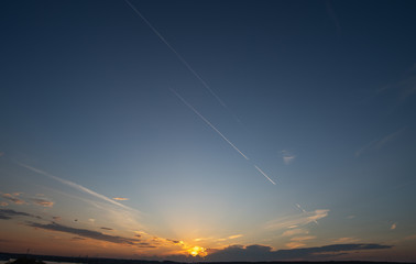 Plane over the horizon. Sunset sky. 