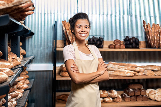Young adult woman standing in family bakery