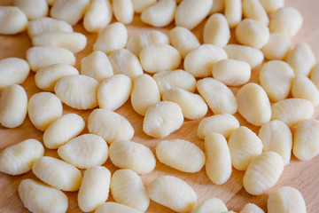 Gnocchi, typical italian pasta, on wooden table, natural light