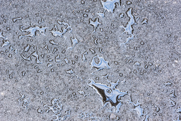 Water on the new asphalt road surface.