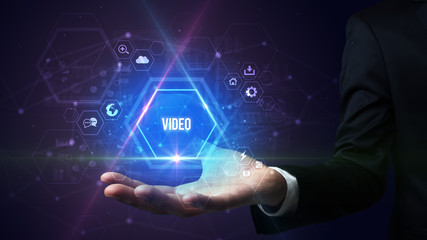 Obraz premium Man hand holding VIDEO inscription, social media concept