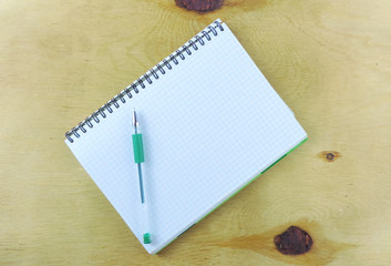       checkered notebook on wooden surface, mock up          