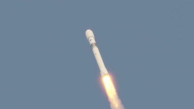 Commercial rocket launch into space with exhaust flames and smoke 4k