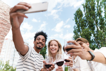 Happy group of friends with red wine