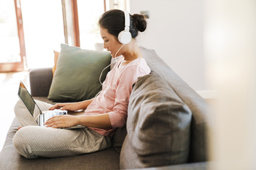 Young woman relaxing on a sofa in the living room