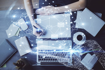 E-mail abstract envelop drawing over hands taking notes background. Concept of electronic mail. Double exposure