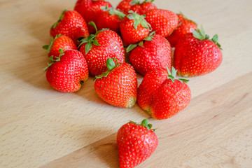Strawberries on wooden table, natural light